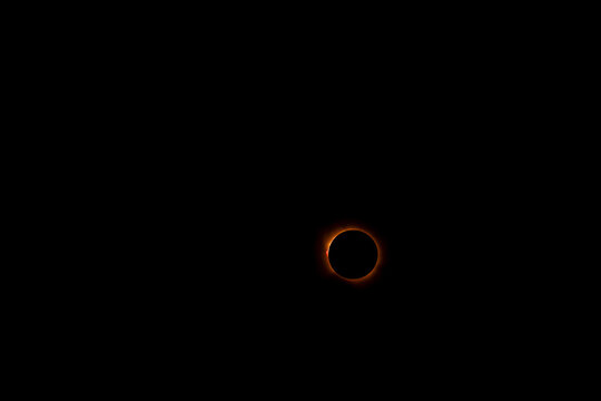 Partial solar eclipse: thin crescent of sunlight as the moon nearly covers the solar disc