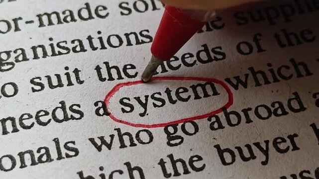 Closeup of hand with red ink pen mark circle around to emphasize or highlight system word print on paper. Symbolic concept of person focus on workflow system improvement for his business.