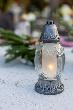 Burning memorial candle with blurred background vertical composition