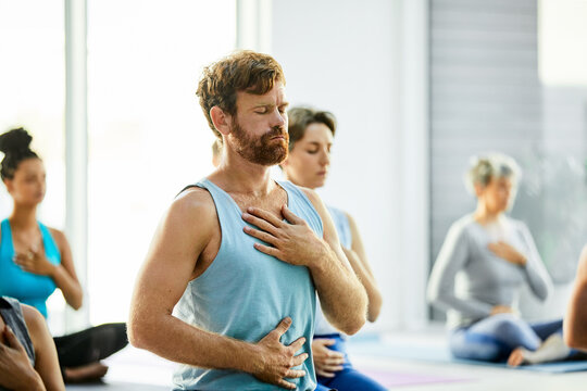 Relax, man and yoga class with belly breathing, holistic wellness and zen to calm nervous system. Mindful, group or grounding practice in studio for chakra balance, meditation or emotional regulation