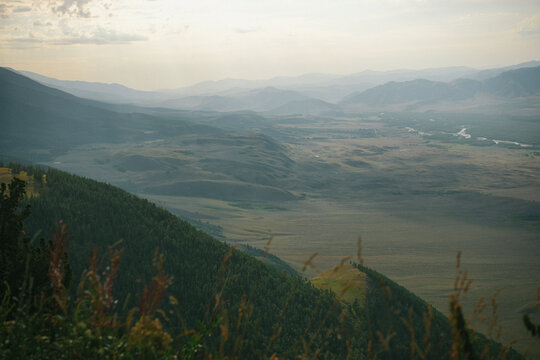 Distant mountain layers enveloped in atmospheric haze above wide valley floor