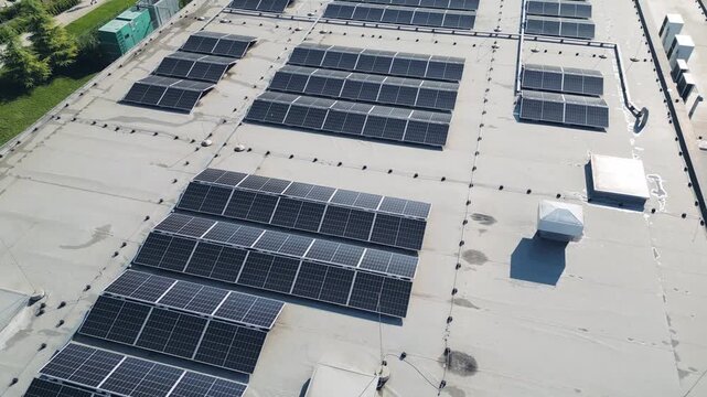 Aerial view of solar panels installed on building flat roof green energy power