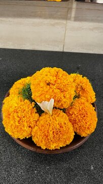 Yellow flower in bowl sat up on the table
