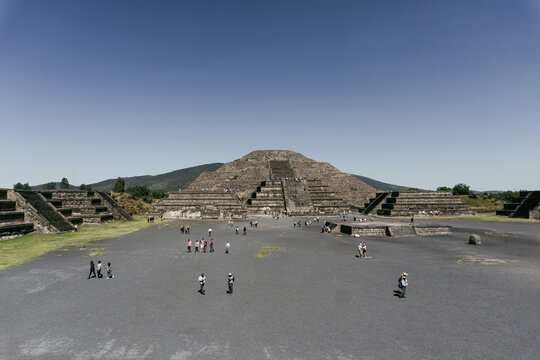 Teotihuacan de Arista, Estado de Mexico, Mexico - 04 November 2017: View of the Pyramid of the Moon at the ancient site of Teotihuacan, with visitors walking across the plaza.