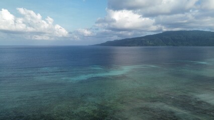 Aerial view of coral reef and turquoise ocean with mountain coastline in Teluk Sulaiman Berau East Kalimantan Indonesia © Paqih