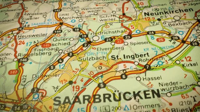 road routes to saarbr&uuml;cken, germany &ndash; gliding view across detailed atlas map
