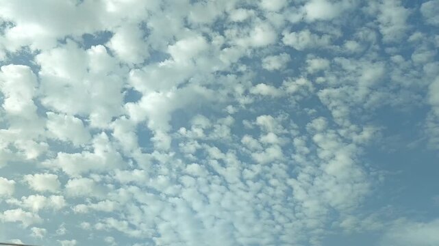 Cirrocumulus clouds moving in the sky early