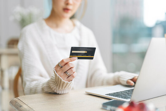Asian woman using credit card using banking online payment digital technology currency wealthy financial
