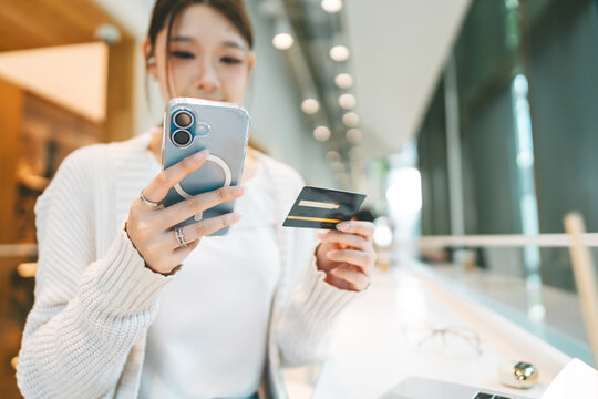 Asian woman using credit card using banking online payment digital technology currency wealthy financial