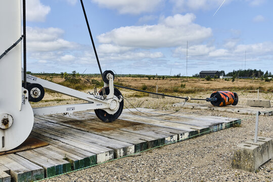 Thisted, Denmark - 11 August 2026: View of the BMS Heavy Cranes 3000 ton electric ring crane at Det Nationale Testcenter for store vindmoller, with wooden mats and industrial equipment.