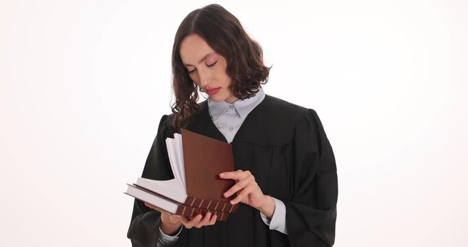 Female judge opens legal code and carefully reads detailed provisions. Lawyer prepares for upcoming scheduled courtroom session on white background