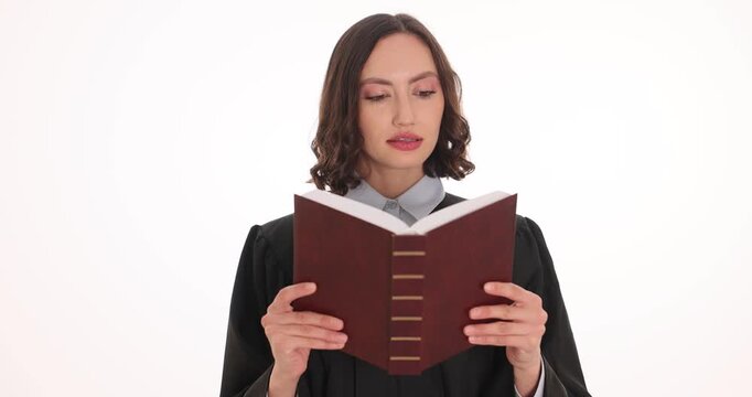 Lady judge reads provisions of legal code during courtroom hearing. Lawyer reads articles during official judicial proceeding on white background