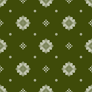 Seamless geometric surface pattern with repeating ornamental medallions, diamond motifs, and small floral accents in white on a dark olive green background.