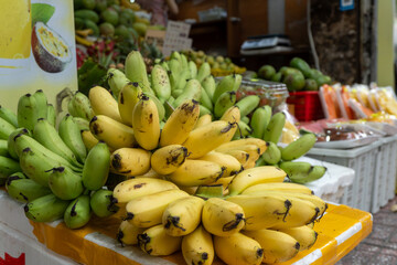 Fresh bananas stacked at outdoor fruit market stall © IbragimovN