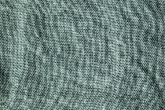 Light blue-gray linen fabric texture background with natural wrinkles and woven textile pattern