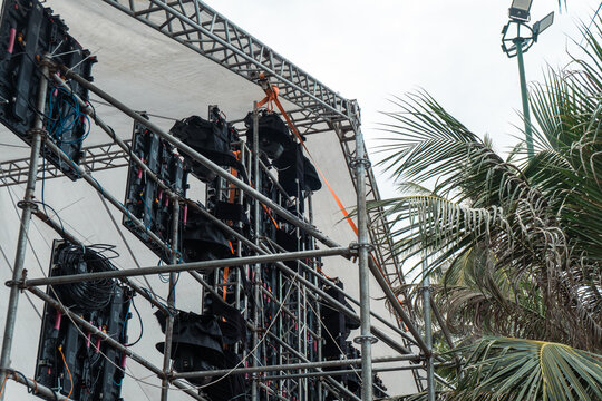 Outdoor concert stage scaffolding under cloudy sky