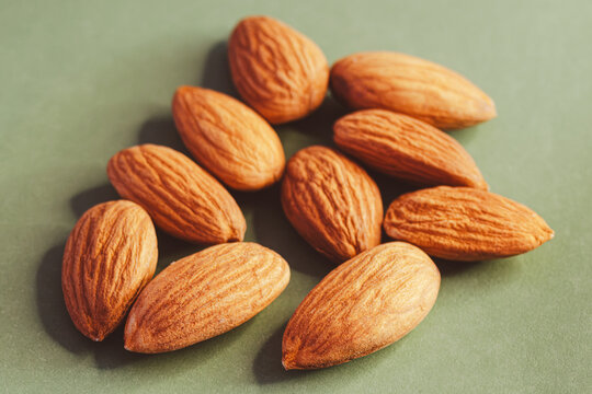 Almonds falling and scattering, a nutritious snack and healthy food ingredient, rich in protein, representing natural wellness and organic eating