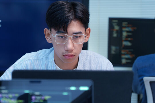 Focused Young Programmer Working on Digital Code
