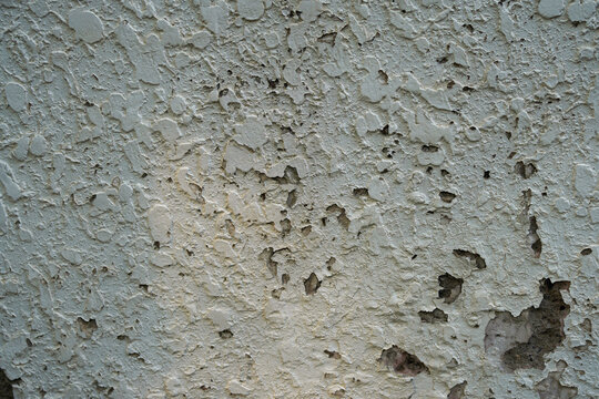 Peeling paint on an old wall showing texture and wear