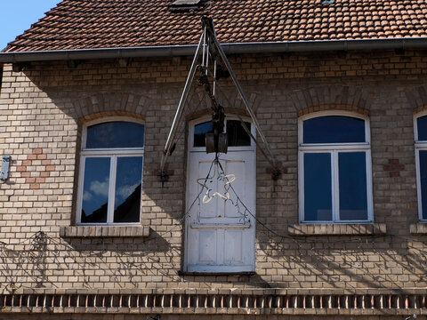 Old Brick Building Facade with Hoist and Christmas Star DecorationB rothers Grimm childhood home village