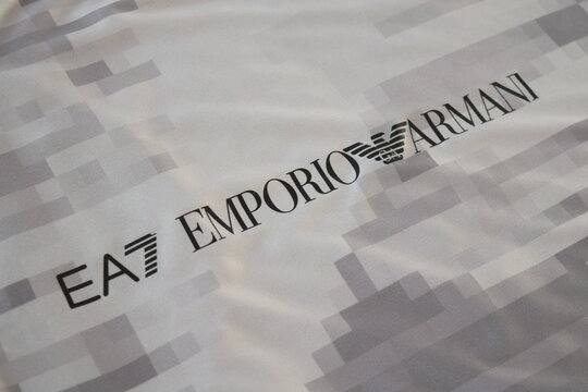 Close up of EA7 Emporio Armani printed logo on grey striped fabric