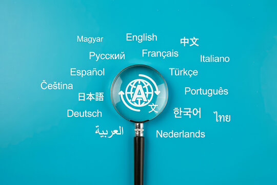 Magnifying glass over translation icon surrounded by various world languages.