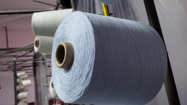 Grey Jersey Fabric Roll Rotating On Industrial Circular Knitting Machine
Large grey jersey knit fabric roll continuously rotating and winding on an industrial circular knitting machine in a Bangladesh