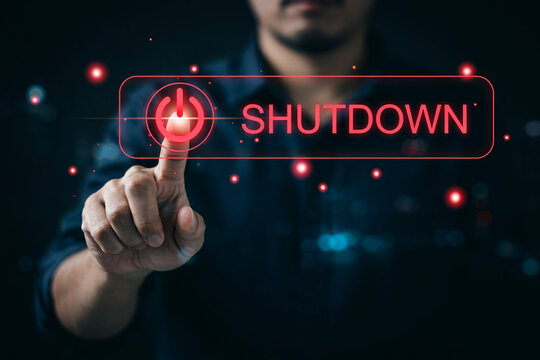 Person pressing red button on digital hologram screen for system shutdown command.
