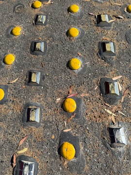 Yellow markers and reflectors on the asphalt at the end of a road