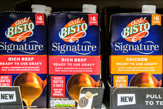Close-Up Of A Row Of Bisto Signature Ready-To-Use Rich Beef And Chicken Gravy Cartons On A Supermarket Shelf