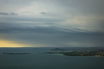Fototapeta premium Dramatic looking storm clouds with corkscrew appearance over Lake Garda, Italy.