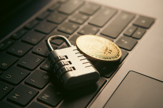 Laptop with bitcoin and padlock. Cryptocurrency security concept.