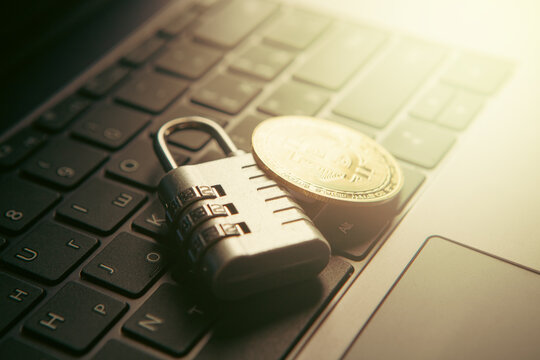 Laptop with bitcoin and padlock. Cryptocurrency security concept.
