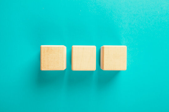 Top view of wooden blocks on turquoise background with copy space