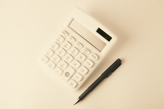 calculator and pen on white background