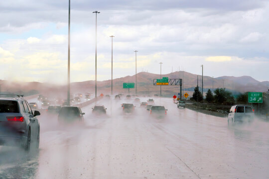 Point of view of traffic on a freeway during a rain storm.