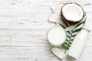 coconut products on white wooden table background. Dairy free milk substitute drink, Flat lay...