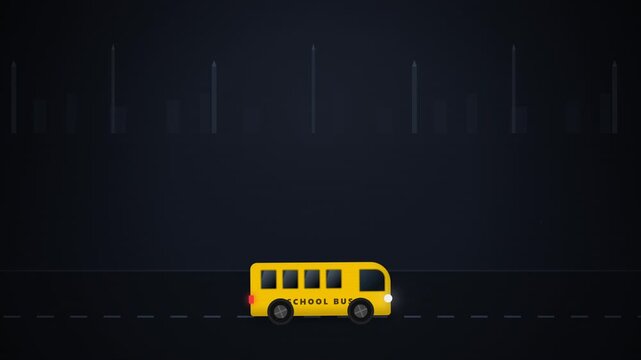 Yellow school bus driving on a dark city street at night.