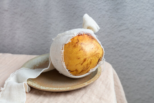 Bruised Pear Wrapped in Cloth on Plate
