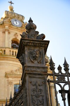 the access staircase and the imposing wrought-iron gate preceding the Cathedral of San Giorgio in Ragusa Ibla