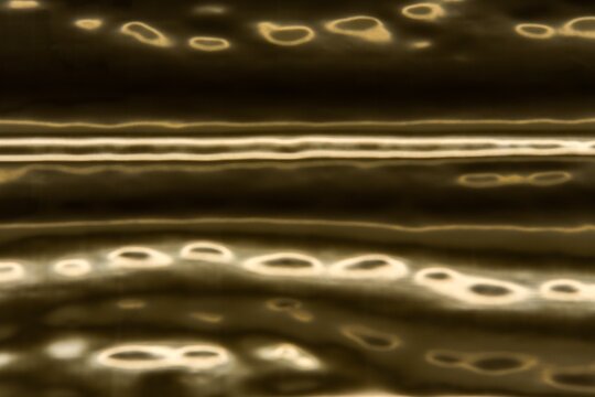 Abstract full frame photo of glowing warm champagne and golden light rings and horizontal lines against dark background. Concept of water reflection, liquid metal, planet atmosphere, space texture, lu