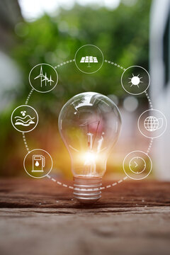 Glowing Light Bulb with Renewable Green Energy Icons