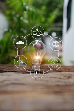 Glowing Light Bulb with Renewable Green Energy Icons
