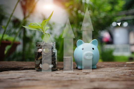 Hand Putting Coin into Piggy Bank with Financial Growth Graph Overlay