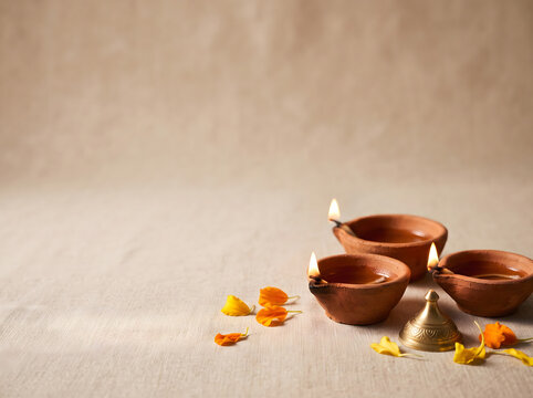 Traditional Clay Diya Lamps Lit for Diwali Celebration with Marigold Flowers and Copy Space Earthen Oil Lamps Deepak for Hindu Festival of Lights, Pooja, and Home Decoration