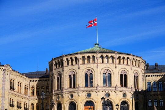 Parliament building Stortingsbygningen in Oslo, Norway. Storting, the Norwegian parliament. Flag of Norway.