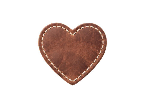 Heart shaped leather patch with white stitching on black background, featuring a rustic handmade charm and romantic vintage style for Valentine's Day and craft industry marketing.