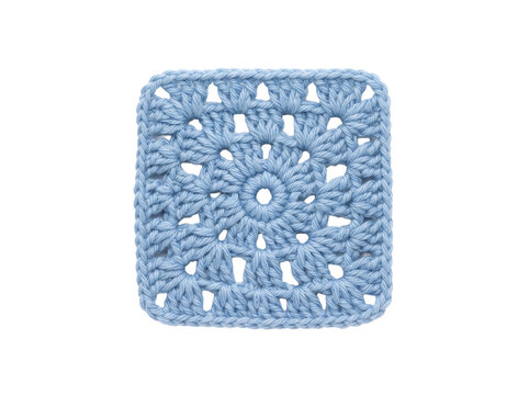 Light blue crocheted granny square isolated on black background, featuring intricate handmade yarn pattern for cozy cottagecore textile art and DIY craft tutorial marketing.