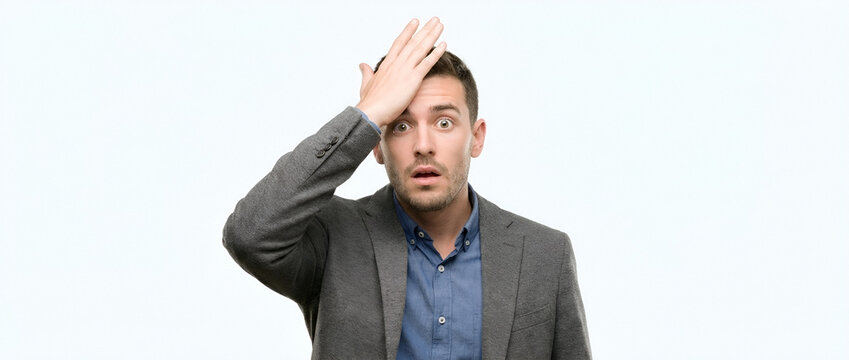 Young man forgetting with hand on forehead in surprise