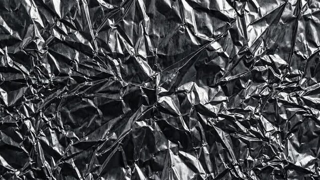 Crumpled silver aluminum foil metallic texture background surface